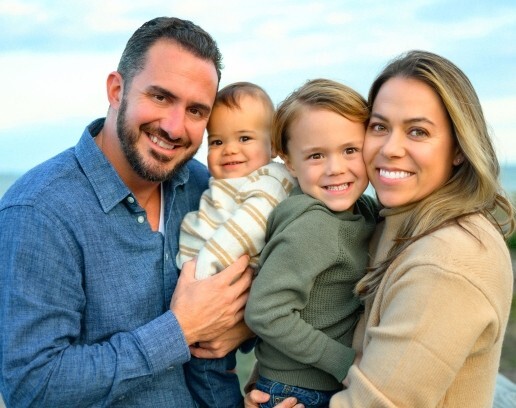 Jennifer posing with family at the beach close up